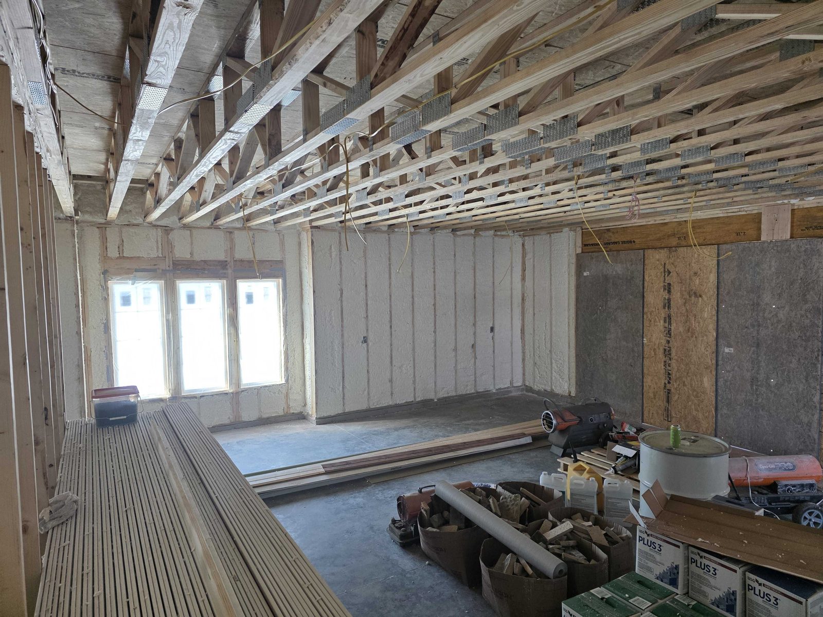 Roof sheathing and trusses prepped for a spray foam application.