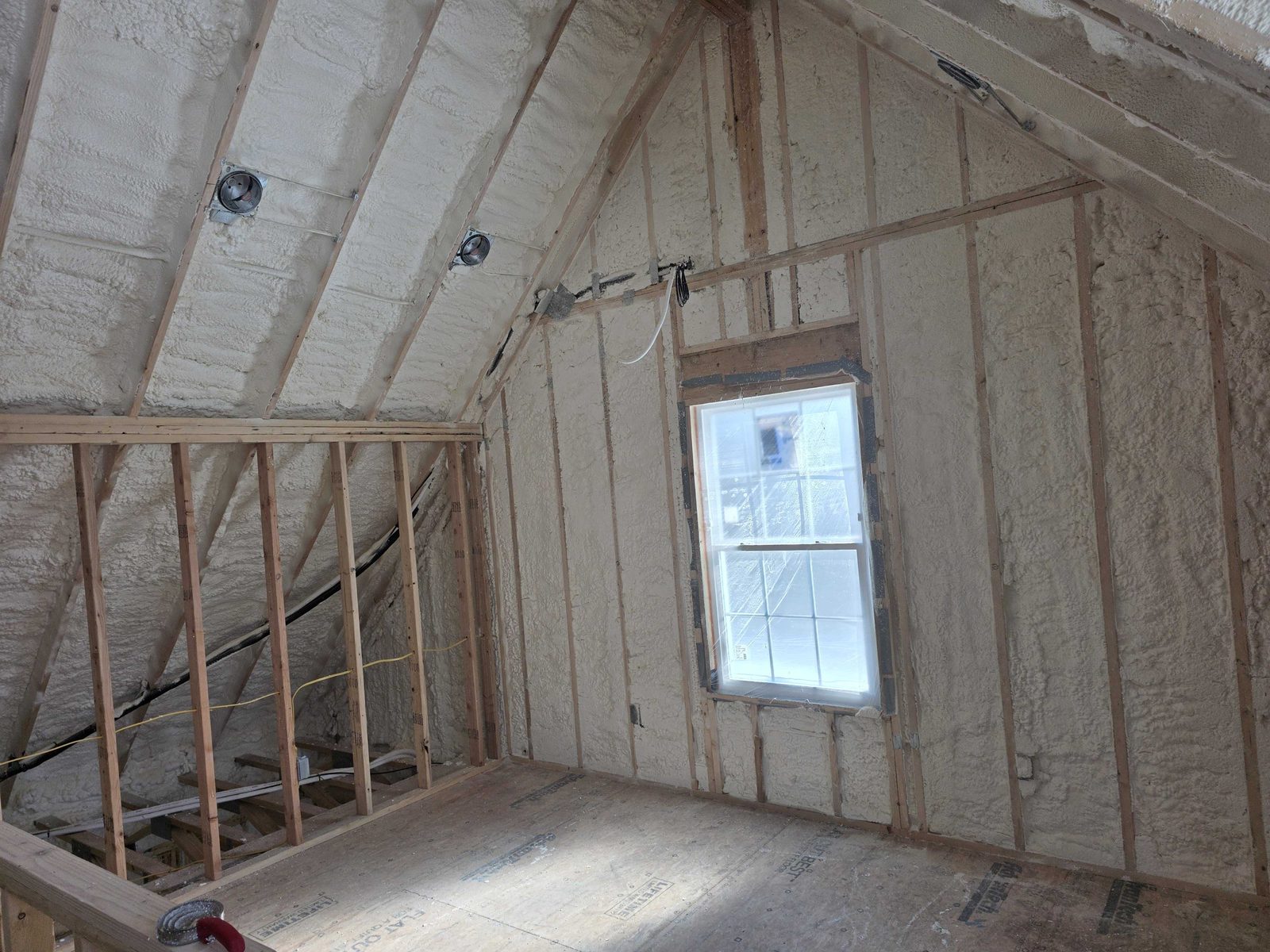 Spray foam follows the roofline in vaulted ceilings for complete coverage.